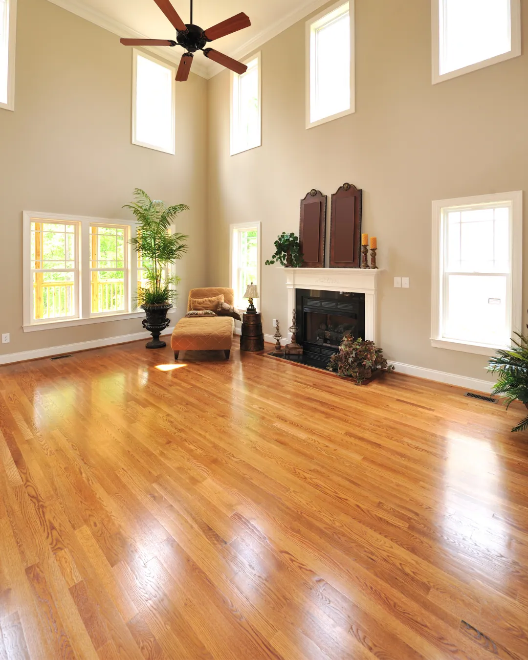 Homeowner inspecting newly installed engineered hardwood floors with TFPros project manager