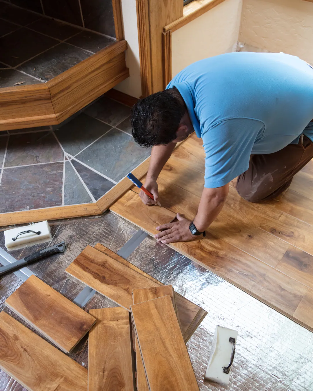 TFPros estimator showing hardwood samples to a homeowner in an Indianapolis living room