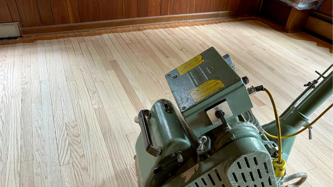 Hardwood floor being sanded and refinished