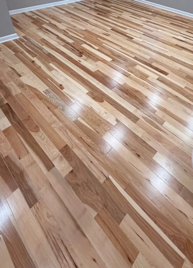 Natural hickory hardwood flooring with mixed grain and tone, finished by the TFPros crew in an Indianapolis home